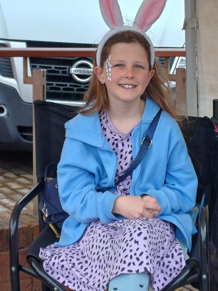 Little girl with face painted with flowers