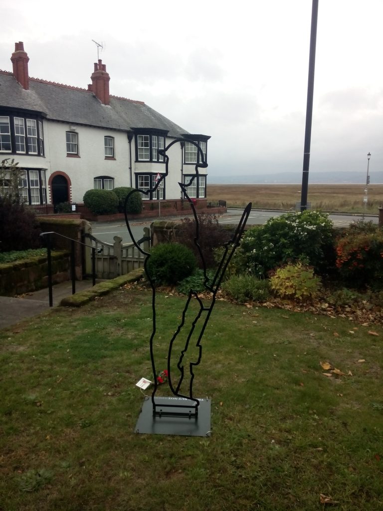 WWI Commemorative Tommy silhouette in the grounds of St Thomas' church looking towards the marshes.