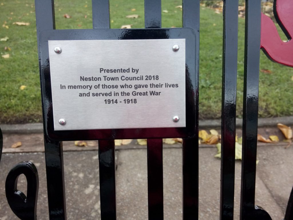 Inscription on the WWI commemorative bench reads "Presented by Neston Town Council 2018 in memory of those who gave their lives and served in the Great War 1914 - 1918.